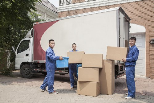 Movers handling large furniture carefully in a Brentford property