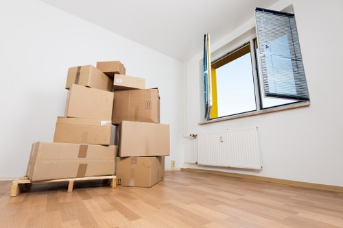Packed moving boxes and furniture ready for transport in Brentford